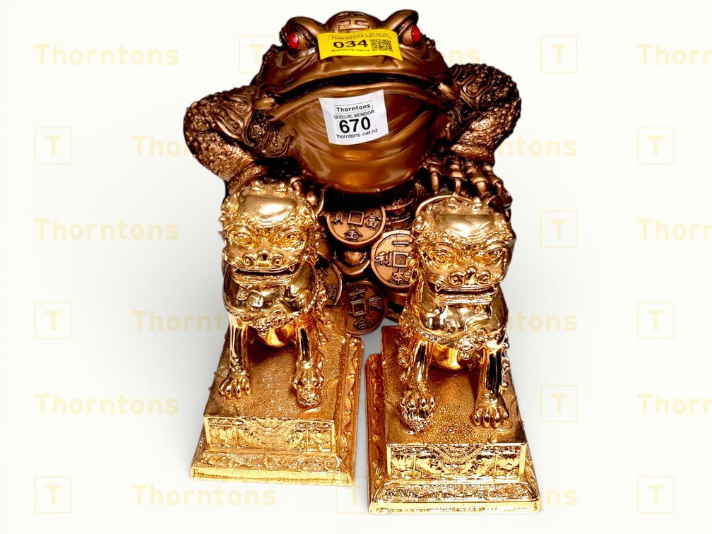 Gold-Coloured Money Frog And Two Dogs